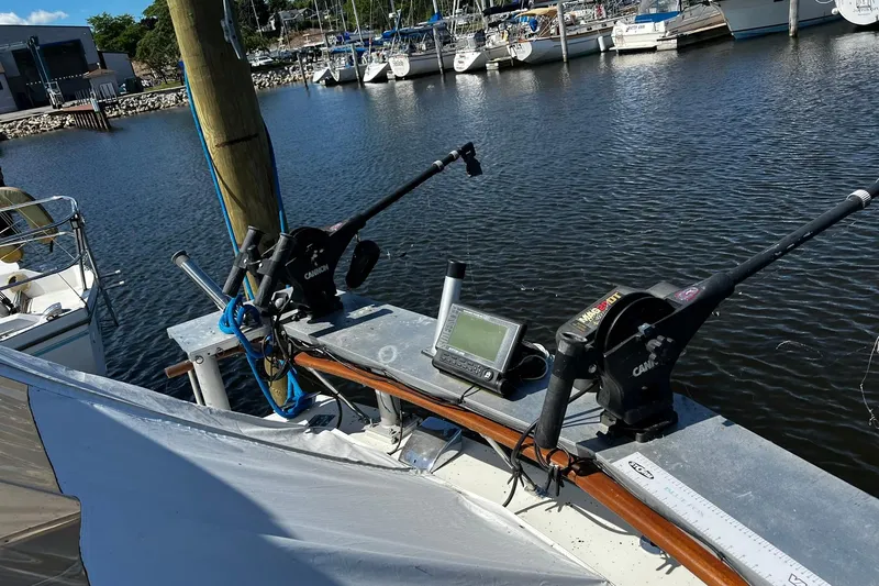 Slide: The Image of 1967 Chris-Craft 31 Commander with fishing equipment docked at a marina. - 15