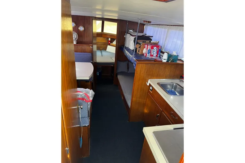 Slide: The Image of Interior of 1967 Chris-Craft 31 Commander boat with kitchen and seating area. - 18