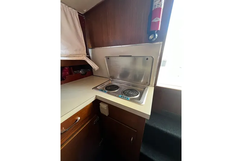 Slide: The Image of 1967 Chris-Craft 31 Commander boat kitchen with stove and wooden cabinetry. - 19