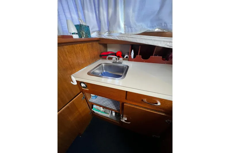 Slide: The Image of 1967 Chris-Craft 31 Commander boat interior with sink and wooden cabinetry. - 22