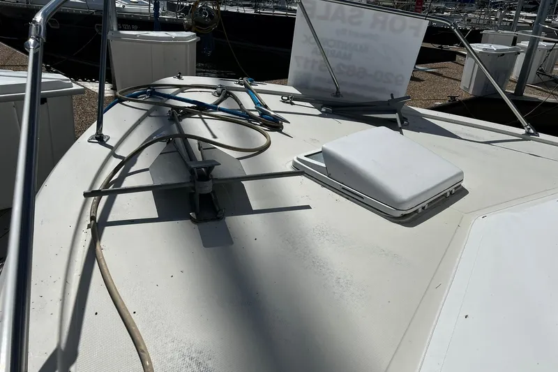 Slide: The Image of 1967 Chris-Craft 31 Commander boat deck with hatch and railing, docked at marina. - 3