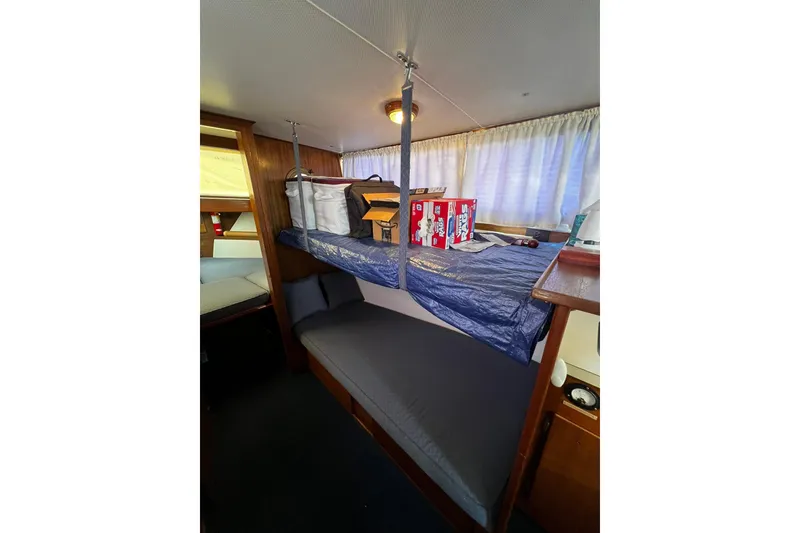 Slide: The Image of Interior of 1967 Chris-Craft 31 Commander with bunk beds and storage items. - 30