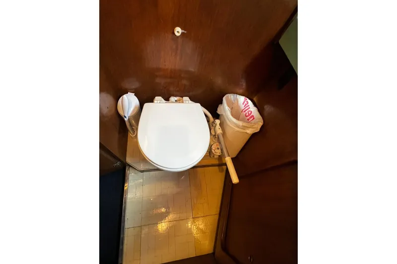 Slide: The Image of 1967 Chris-Craft 31 Commander boat bathroom with toilet and waste bin. - 33