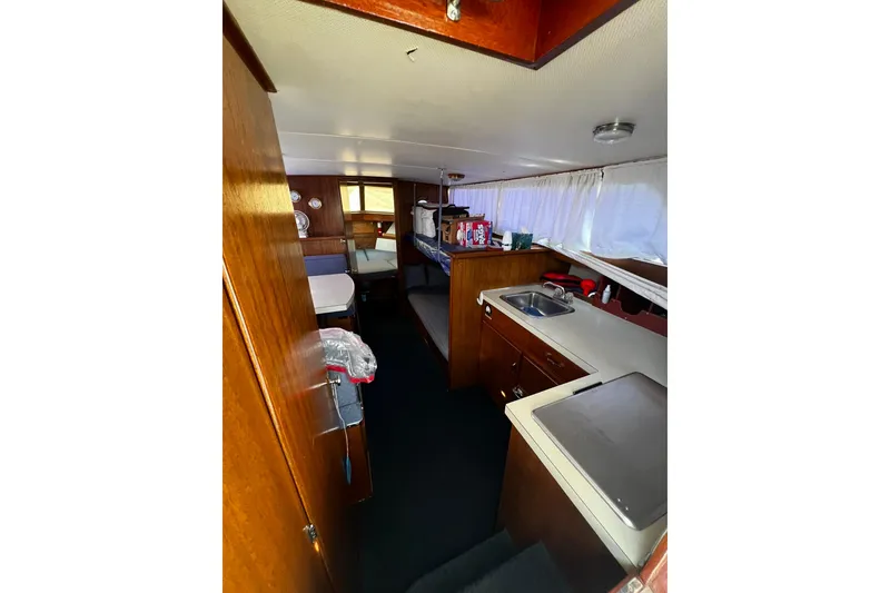 Slide: The Image of 1967 Chris-Craft 31 Commander interior with wood finish, kitchenette, and seating area. - 35