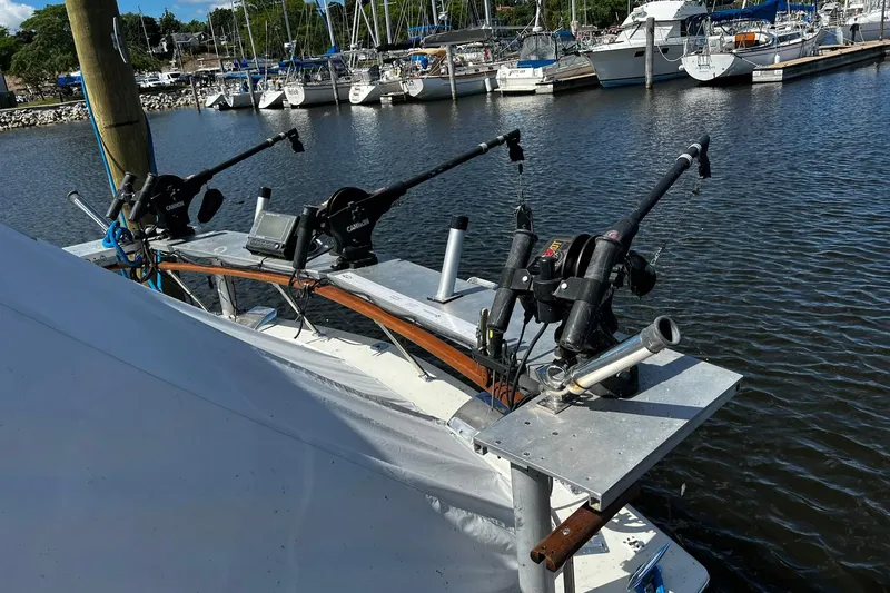 Slide: The Image of 1967 Chris-Craft 31 Commander with fishing gear docked at a marina. - 5