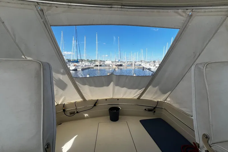 Slide: The Image of 1967 Chris-Craft 31 Commander interior view with marina backdrop and sailboats. - 7