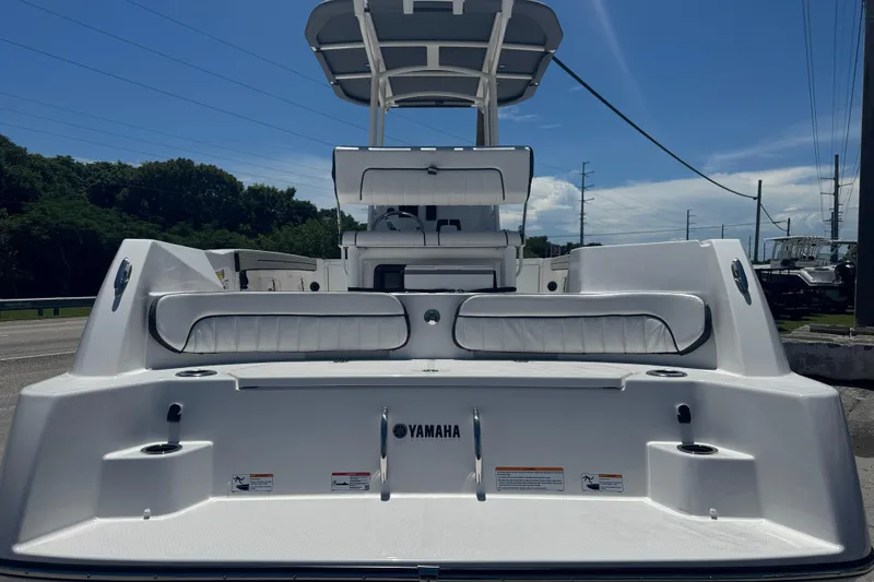 Slide: The Image of 2026 Yamaha Boats 220 FSH Sport, rear view, showcasing seating and deck features. - 2