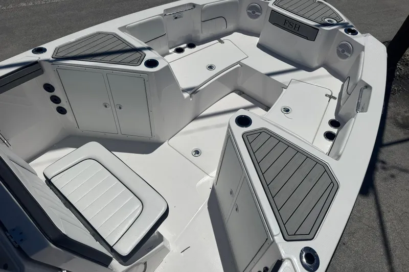 Slide: The Image of 2026 Yamaha Boats 220 FSH Sport interior with seating and storage compartments. - 7