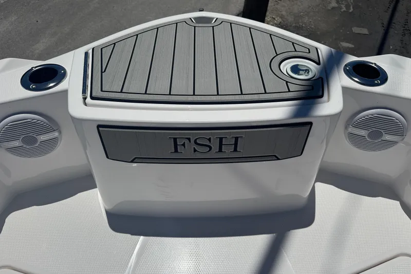 Slide: The Image of 2026 Yamaha Boats 220 FSH Sport deck with speakers and cup holders. - 8