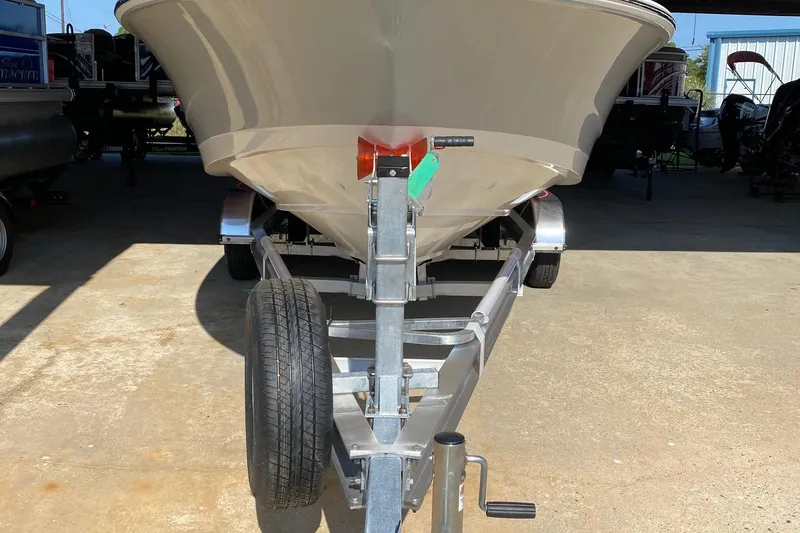 Slide: The Image of 2026 Boston Whaler 220 Dauntless boat on trailer in a garage. - 4