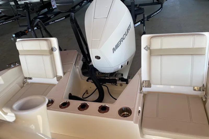 Slide: The Image of 2026 Boston Whaler 220 Dauntless boat interior with Mercury engine and seating. - 9