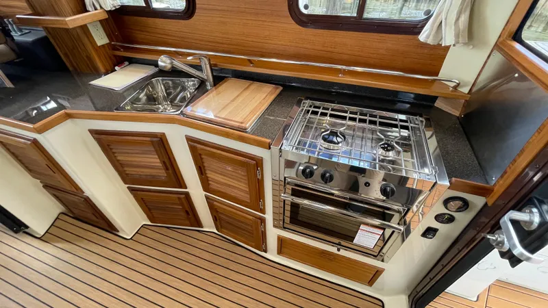 Slide: The Image of Interior of 2023 Ranger Tugs R-31 CB, featuring wood accents and modern amenities. - 15