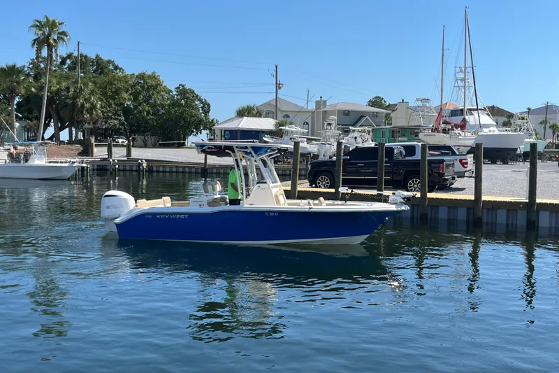 Slide: The Image of 2018 Key West 239 FS boat docked in a marina with clear blue water. - 1