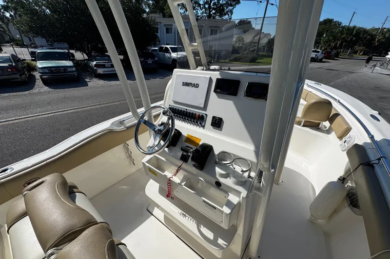 Slide: The Image of 2018 Key West 239 FS boat interior with steering console and seating. - 14