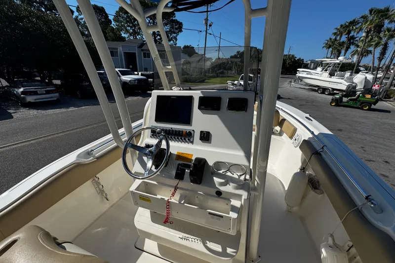 Slide: The Image of 2018 Key West 239 FS boat interior with steering wheel and control panel. - 15
