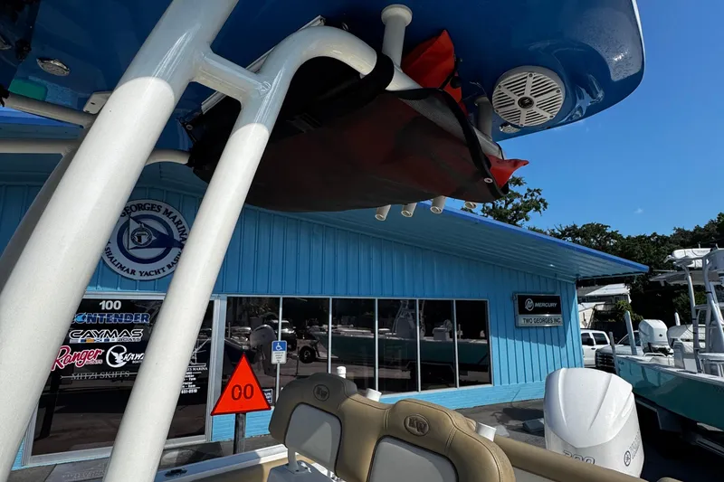 Slide: The Image of 2018 Key West 239 FS boat at marina with blue building background. - 17
