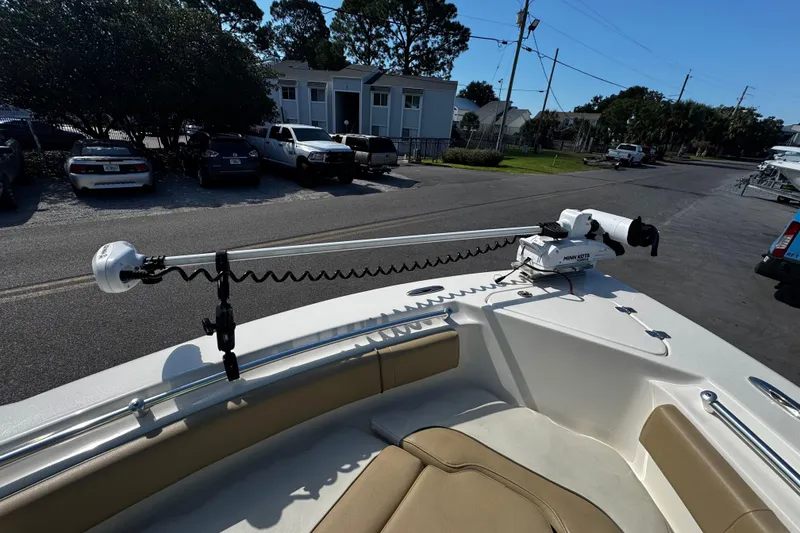 Slide: The Image of 2018 Key West 239 FS boat with Minn Kota trolling motor, parked near residential area. - 20