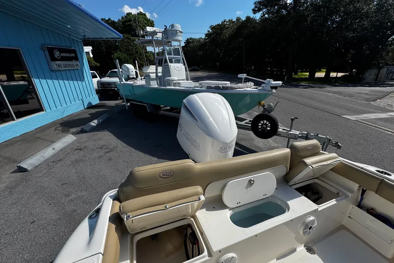Slide: The Image of 2018 Key West 239 FS boat with Yamaha engine parked outside a blue building. - 22