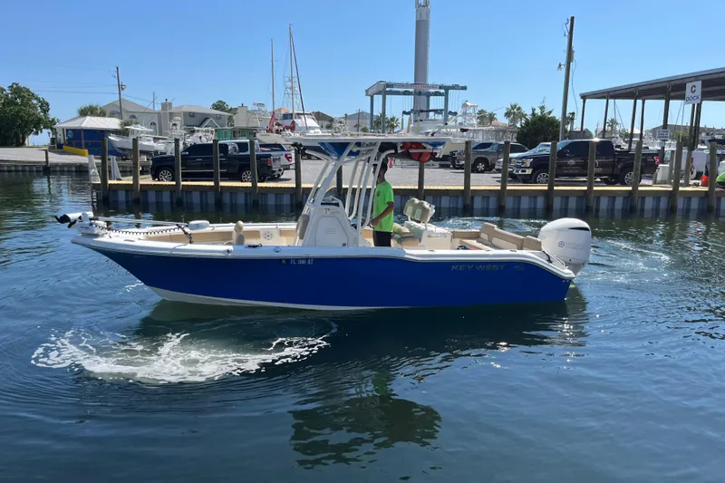 Slide: The Image of 2018 Key West 239 FS boat in marina, blue hull, calm water, sunny day. - 4