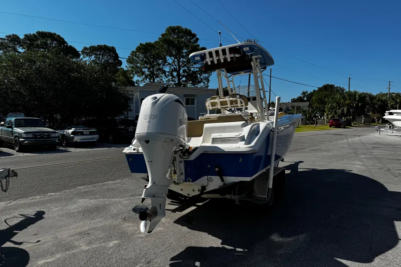 Slide: The Image of 2018 Key West 239 FS boat with outboard motor on a trailer in a parking area. - 7