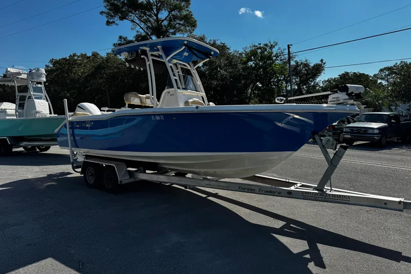 Slide: The Image of 2018 Key West 239 FS boat on trailer, blue hull, parked outdoors. - 8