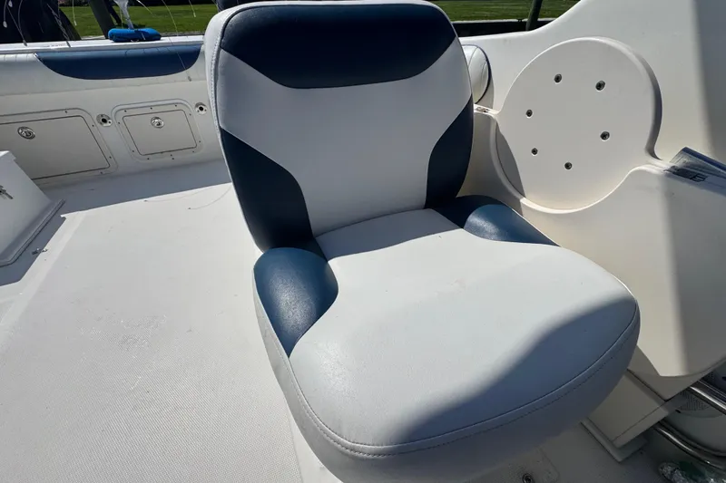 Slide: The Image of Boat seat on a 2000 World Cat 246 DC, featuring blue and white upholstery. - 12