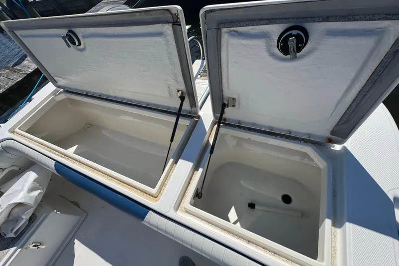 Slide: The Image of Open storage compartments on a 2000 World Cat 246 DC boat deck. - 13