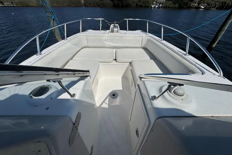 Slide: The Image of Bow seating area of a 2000 World Cat 246 DC boat on the water. - 16