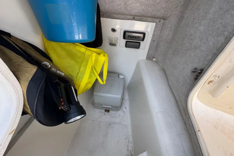 Slide: The Image of Interior of a 2000 World Cat 246 DC boat with storage items and equipment. - 20