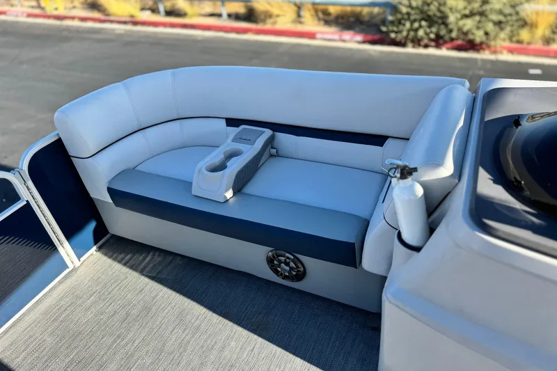 Slide: The Image of 2022 Godfrey SWEETWATER 2086 boat interior with cushioned seating and cup holders. - 11