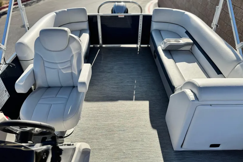 Slide: The Image of 2022 Godfrey SWEETWATER 2086 pontoon boat interior with plush seating and steering console. - 12