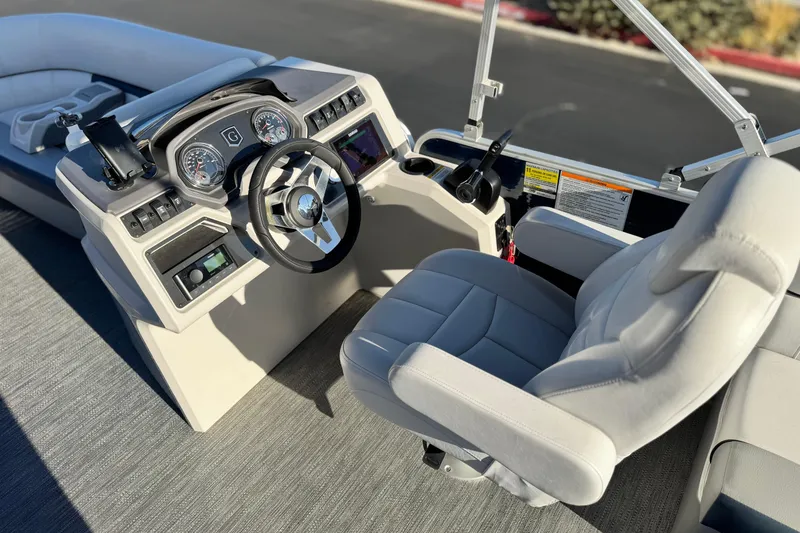Slide: The Image of 2022 Godfrey SWEETWATER 2086 boat interior with steering wheel and captain's chair. - 19