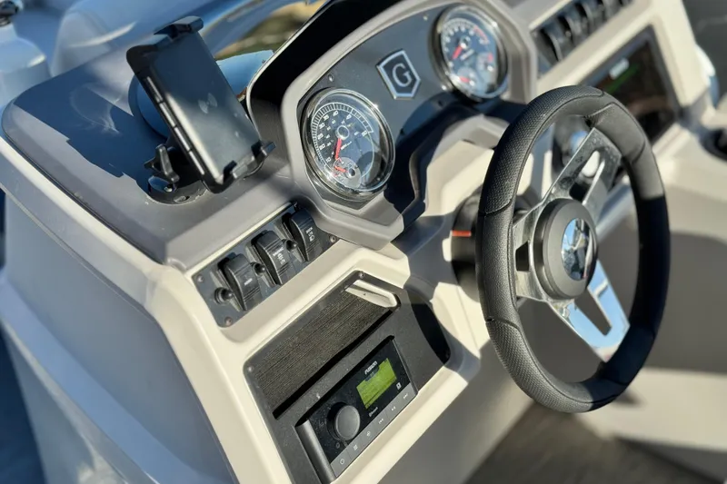 Slide: The Image of Dashboard of 2022 Godfrey SWEETWATER 2086 boat with steering wheel and gauges. - 21