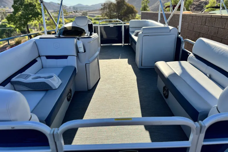 Slide: The Image of 2022 Godfrey SWEETWATER 2086 pontoon boat interior with spacious seating and scenic view. - 8
