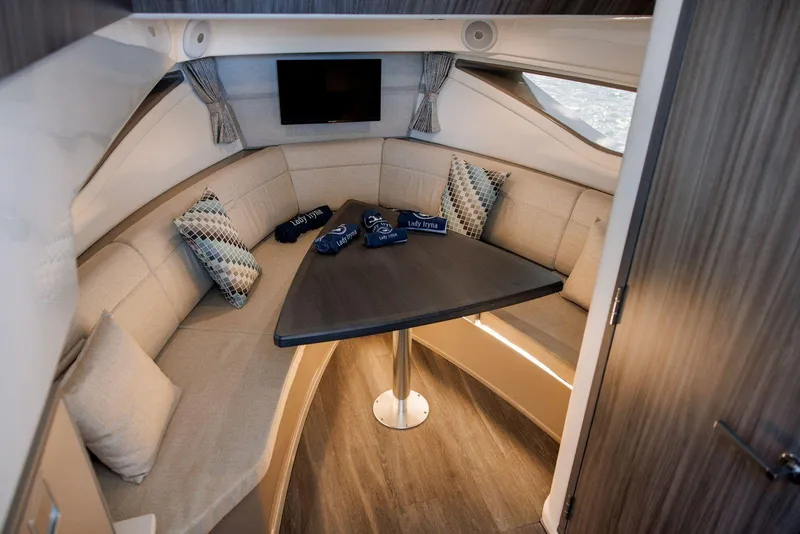 Slide: The Image of Luxurious interior of 2022 Sea Ray Sundancer 320 Outboard with cozy seating and modern decor. - 12