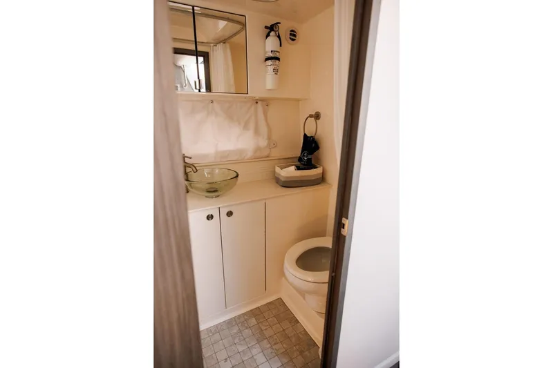 Slide: The Image of 2022 Sea Ray Sundancer 320 Outboard bathroom with modern sink and toilet. - 13