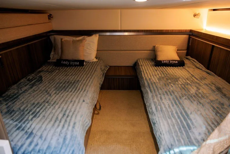 Slide: The Image of 2022 Sea Ray Sundancer 320 Outboard cabin with twin beds and cozy decor. - 14