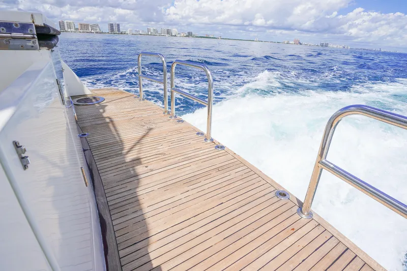 Slide: The Image of Monte Fino 82MY yacht deck with ocean view, 2001 model, cruising near city skyline. - 15