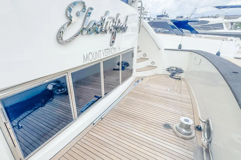 Slide: The Image of Luxury Monte Fino 82MY yacht deck, 2001 model, with sleek wooden flooring and elegant design. - 16