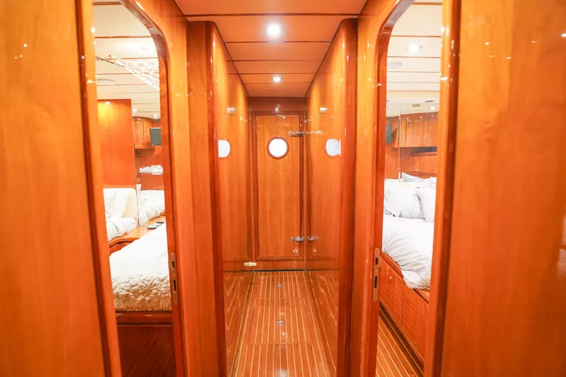 Slide: The Image of Luxurious Monte Fino 82MY 2001 yacht bedroom with wood paneling and plush bedding. - 35