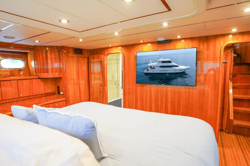 Slide: The Image of Luxurious Monte Fino 82MY 2001 yacht bedroom with elegant wood finish and plush bedding. - 36