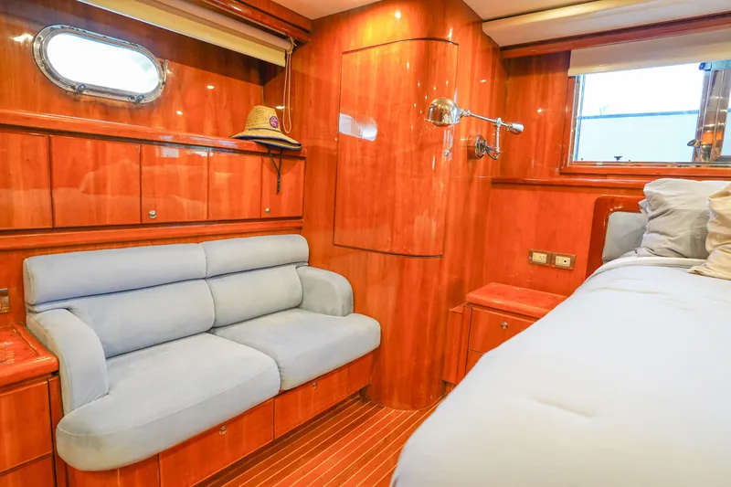 Slide: The Image of Luxurious Monte Fino 82MY 2001 yacht bedroom with wood paneling and plush bedding. - 37