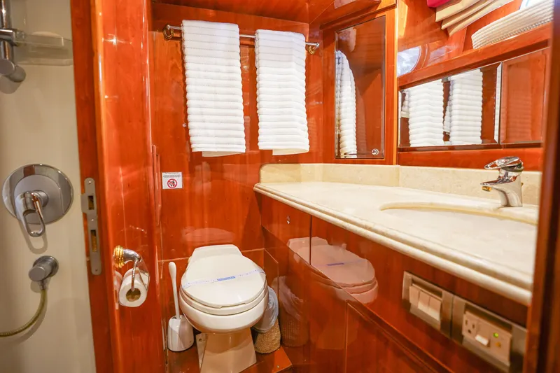 Slide: The Image of Luxurious bedroom interior of 2001 Monte Fino 82MY yacht with wood paneling and cozy bedding. - 43