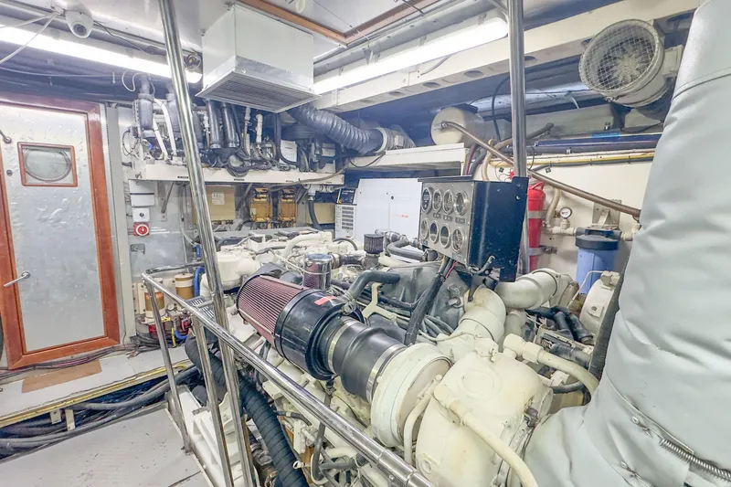 Slide: The Image of Engine room of 2001 Monte Fino 82MY yacht, featuring complex machinery and control panels. - 54