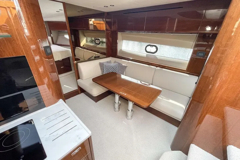 Slide: The Image of Luxurious interior of 2022 Princess V50 yacht with elegant wood finishes and cozy seating area. - 18
