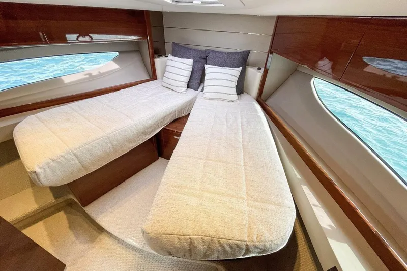 Slide: The Image of Luxurious cabin interior of 2022 Princess V50 yacht with twin beds and elegant wood finish. - 20
