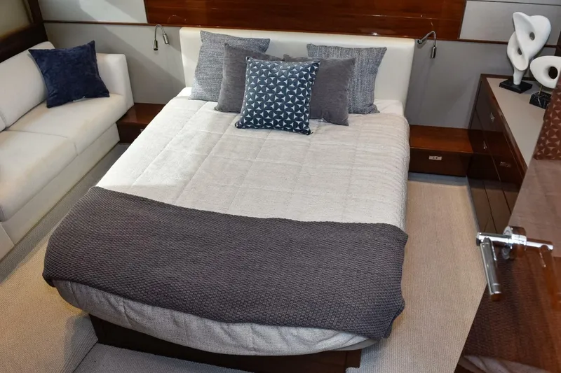 Slide: The Image of Luxurious bedroom interior on a 2022 Princess V50 yacht, featuring elegant bedding and decor. - 25