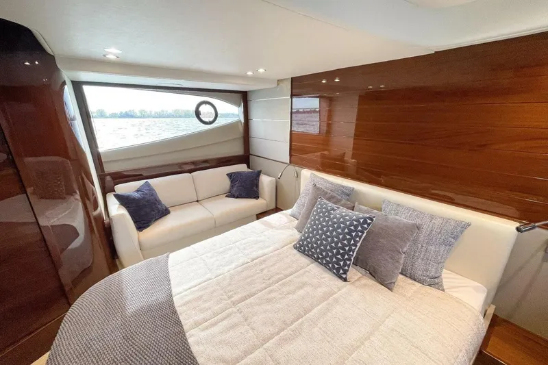 Slide: The Image of Luxurious 2022 Princess V50 yacht interior with elegant bedding and seating. - 26