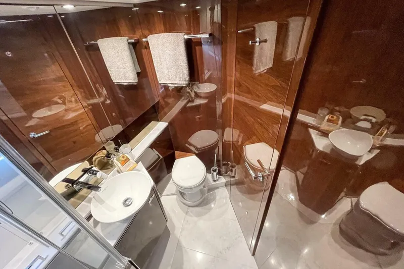 Slide: The Image of Luxurious bathroom in 2022 Princess V50 yacht with elegant wood paneling and modern fixtures. - 28