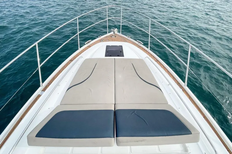 Slide: The Image of 2022 Princess V50 yacht bow with sunbed, surrounded by ocean water. - 7